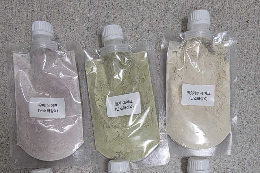Hand-labelled test pouches of ube, matcha and grain shake powder.